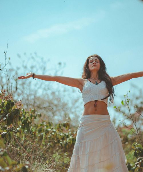 Woman performing a gentle back stretching pose in a calm environment.